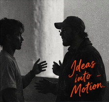 Two collaborators on set. Ideas into Motion.